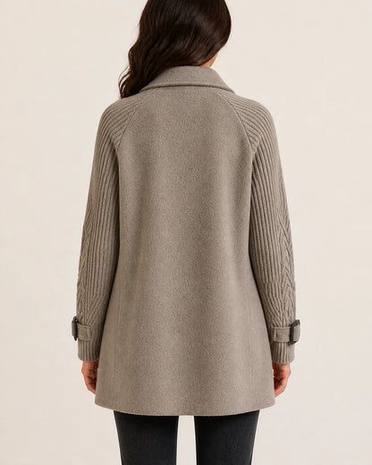 Taupe mid-length coat with knit sleeves, back view.